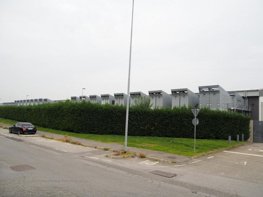 engineer working among rows of data centre servers